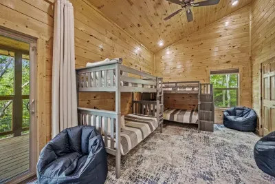 Bunk room with a full over full and twin over twin bunks; 4 bean bag chairs plus Smart TV & board games