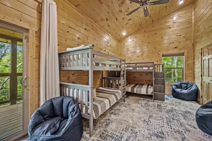 Bunk room with a full over full and twin over twin bunks; 4 bean bag chairs plus Smart TV & board games