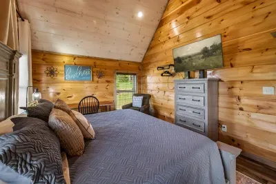 Upstairs bedroom with king bed, desk and chair and Smart TV