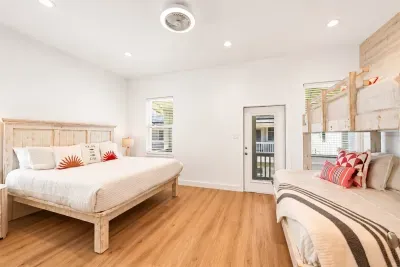 Large master bedroom with king bed and bunk bed with queen on bottom, twin on top and twin trundle below.