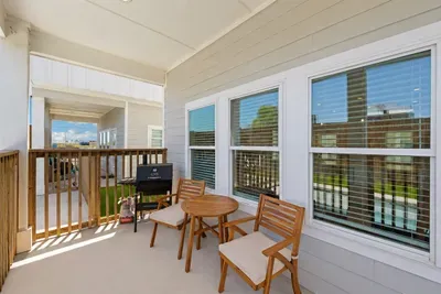 Porch area between the pool and  home