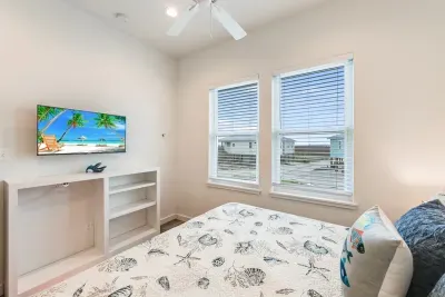 Beach-themed bedroom with natural light.