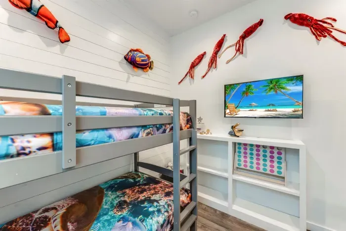 Twin-over-full bunk with marine-themed bedding.