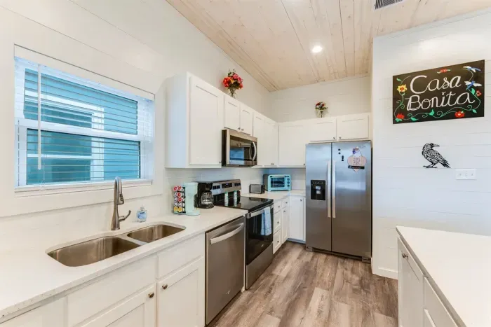 Modern kitchen with stainless steel appliances.
