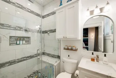 One of two large walk in shower with rain shower & jets