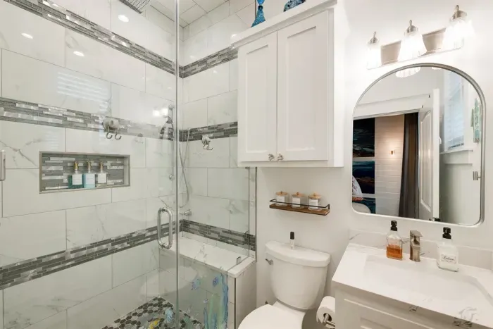 One of two large walk in shower with rain shower & jets