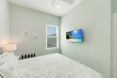 Inviting bedroom with coastal décor and calming seafoam tones