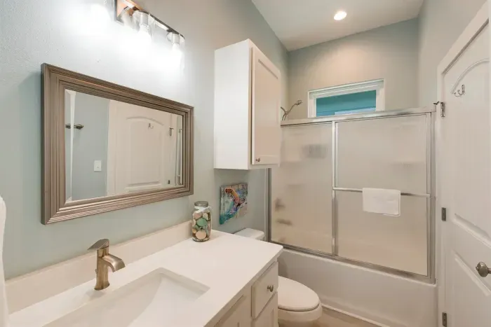 Modern bathroom with vanity, shower, and coastal décor