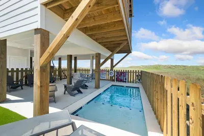 Take a refreshing dip in your own private pool right under the shade of the beach house. With plenty of seating and a giant Connect Four game nearby, it’s the ultimate backyard setup for endless group fun.