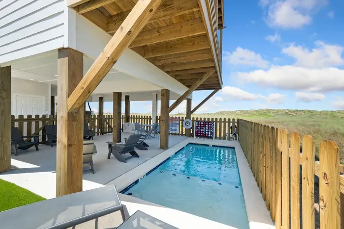 Take a refreshing dip in your own private pool right under the shade of the beach house. With plenty of seating and a giant Connect Four game nearby, it’s the ultimate backyard setup for endless group fun.