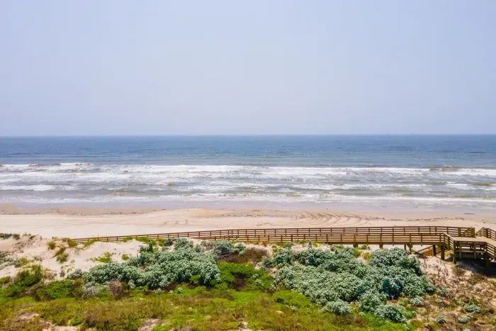 Boardwalk to the beach located directly in front of the house.