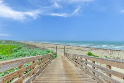 Private golf cart friendly boardwalk to the beach