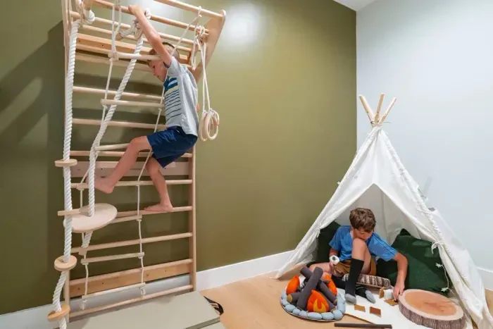 This walk-in closet has been transformed into a fun kids’ play area with a teepee, a pretend fire pit for roasting marshmallows, and a Swedish ladder for climbing and play.
