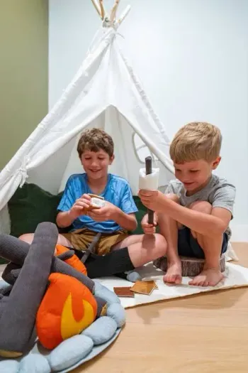 This walk-in closet has been transformed into a fun kids’ play area with a teepee and pretend fire pit for making s'mores.