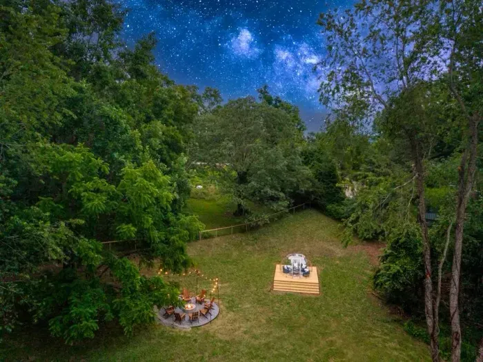 Take in the backyard from above—an inviting fire pit for eight and a cozy stargazing dome, perfect spots to unwind under the stars.