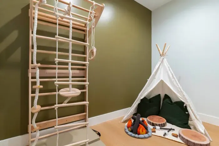 This walk-in closet has been transformed into a fun kids’ play area with a teepee, a pretend fire pit for roasting marshmallows, and a Swedish ladder for climbing and play.