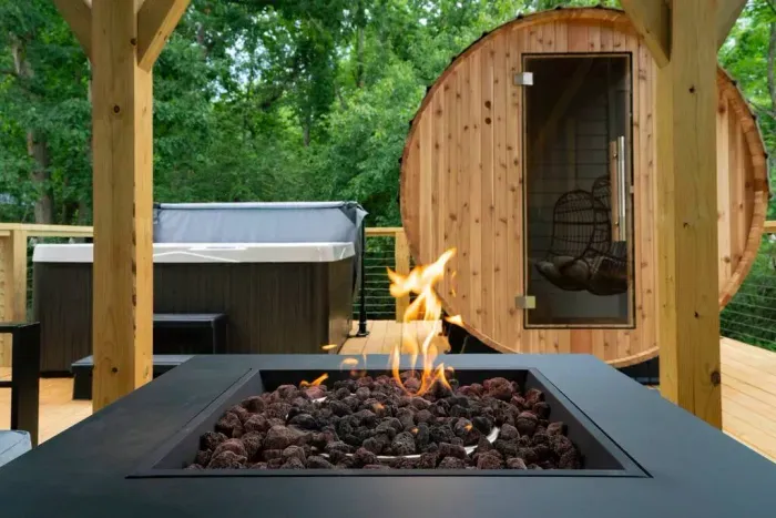 Unwind on the back deck with a 6-person hot tub, barrel sauna, and a cozy propane fire pit.