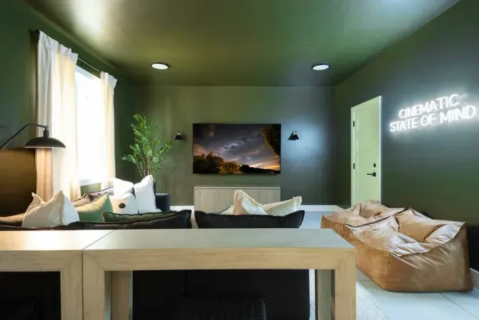 Kick back in the theater room with an 85" TV, a roomy sectional, and comfy Pottery Barn leather bean bag chairs perfect for kids to lounge in.