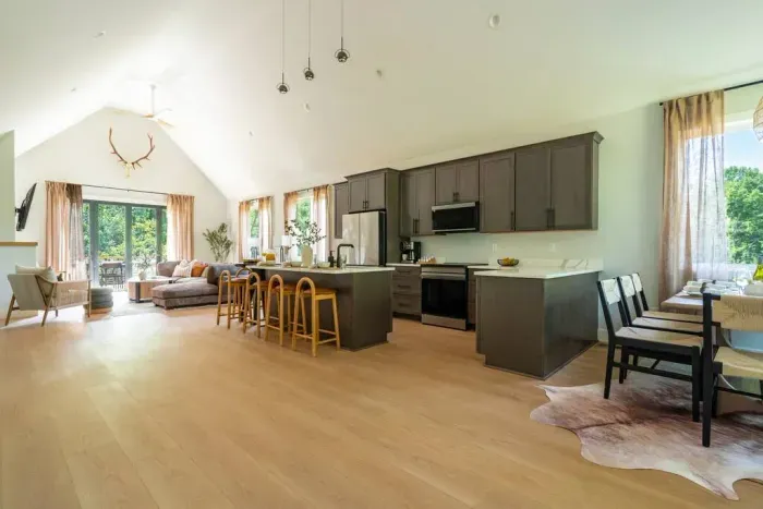 The moment you walk in, the open layout and vaulted ceilings make the space feel larger than life—bright, airy, and perfect for gathering around the kitchen and dining areas.