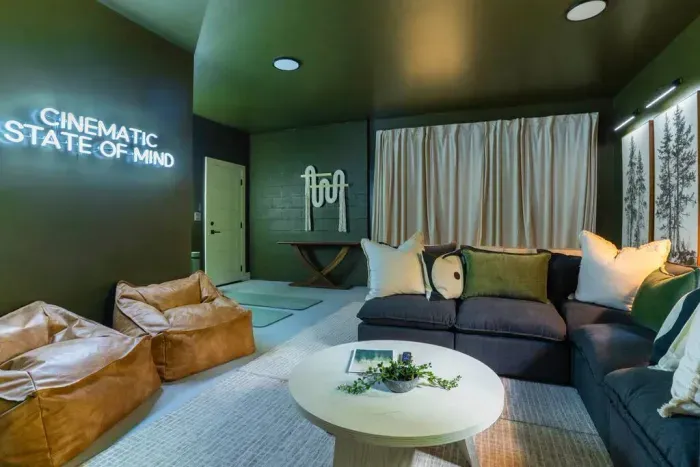 Kick back in the theater room with an 85" TV, a roomy sectional, and comfy Pottery Barn leather bean bag chairs perfect for kids to lounge in.