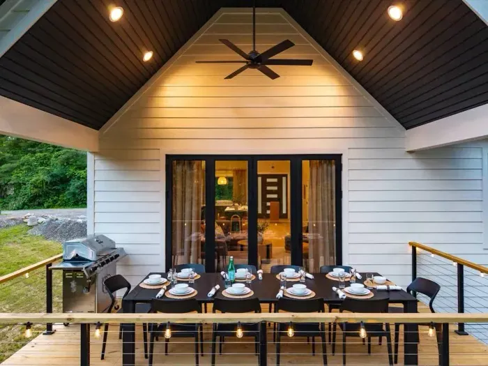 Enjoy dinner for ten on the upper deck, complete with easy access to the grill. Sliding doors open to the bright living room, kitchen, and indoor dining—perfect for relaxed gatherings inside and out.