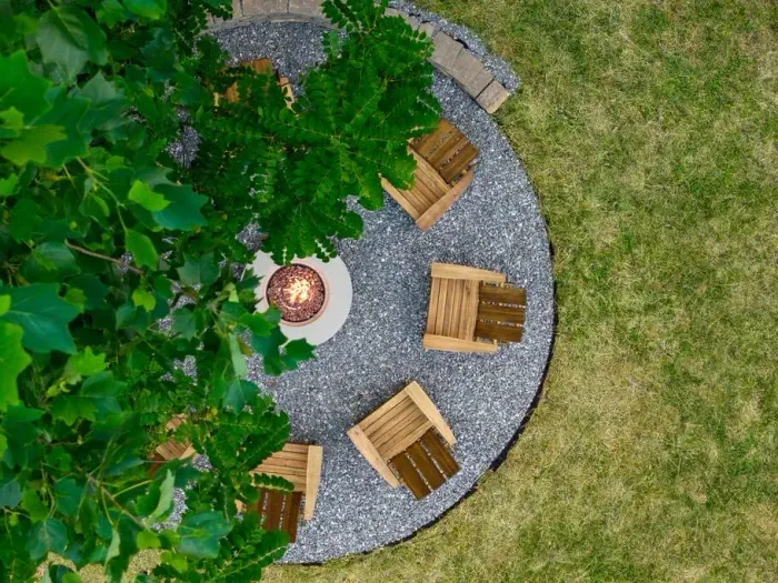 Tucked into the backyard under string lights, this spacious fire pit area seats eight in Adirondack chairs—perfect for evening hangs and easy conversation around the fire.