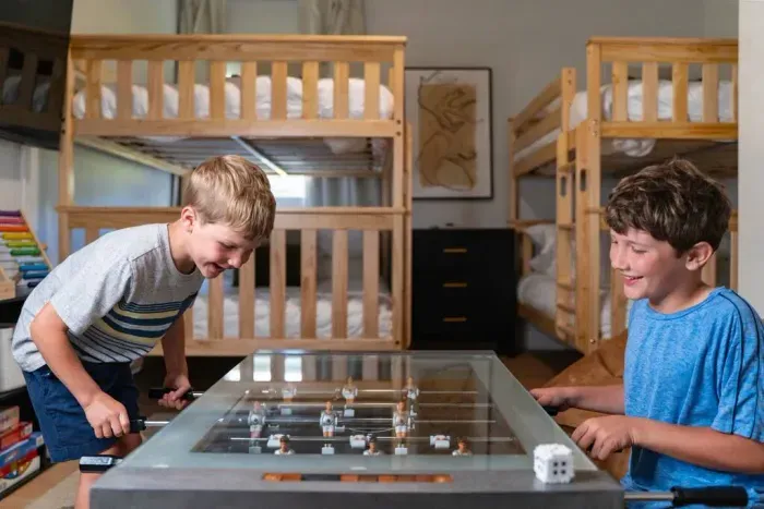 Foosball, laughs, and good times in the bunk room—kid-approved fun all around.
