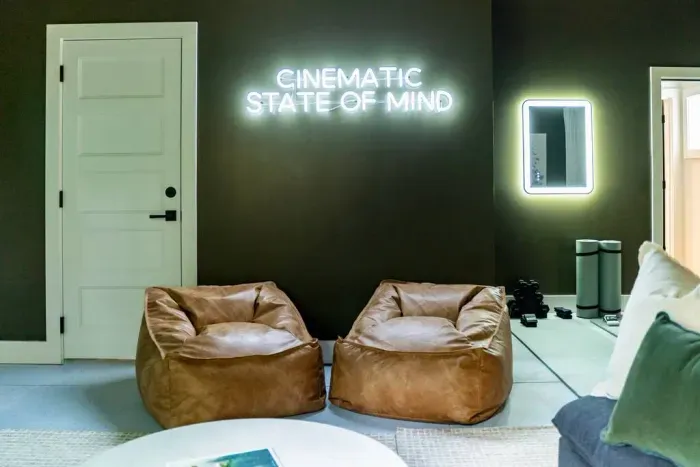 Kick back in the theater room with an 85" TV, a roomy sectional, and comfy Pottery Barn leather bean bag chairs perfect for kids to lounge in.