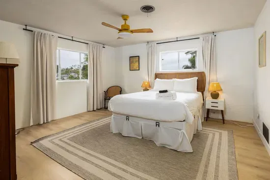 Relax and recharge in this bright, breezy bedroom with a comfy queen bed, soft linens, and plenty of natural light, your perfect spot to unwind after a day out.