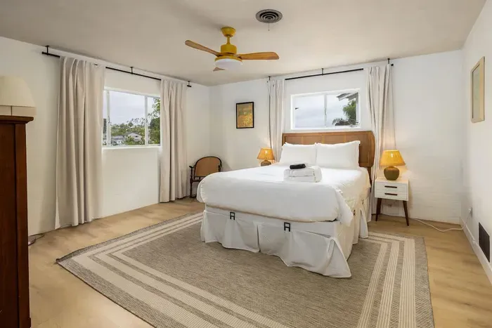 Relax and recharge in this bright, breezy bedroom with a comfy queen bed, soft linens, and plenty of natural light, your perfect spot to unwind after a day out.