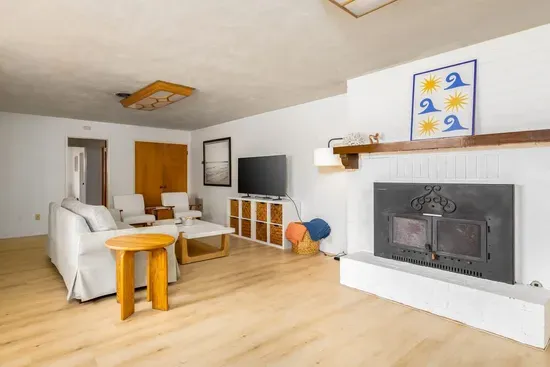 Cozy and inviting living room with a wood-burning fireplace, smart TV, and comfortable seating, perfect for relaxing after a day of adventure!