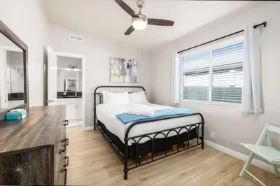 A peaceful bedroom with a comfortable bed, ceiling fan, and private en-suite bath. Everything you need for a restful stay.
