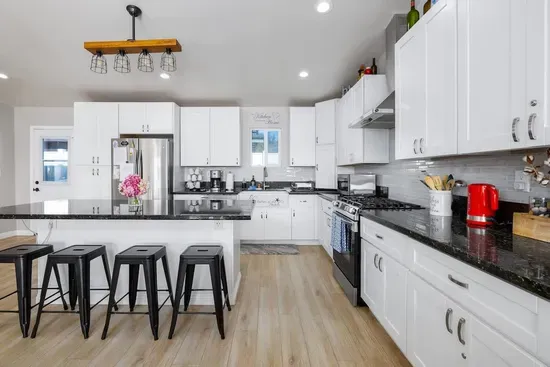 A bright, fully-equipped kitchen that makes cooking a joy. Enjoy modern appliances, ample space, and a breakfast bar for four!