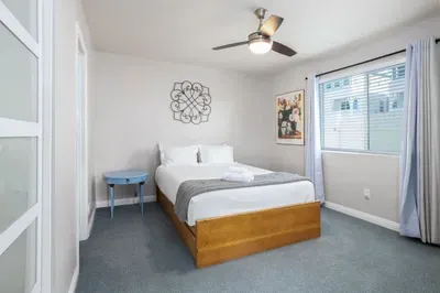 Unwind in this peaceful bedroom designed for relaxation. Enjoy a comfortable queen-size bed, a cooling ceiling fan.
