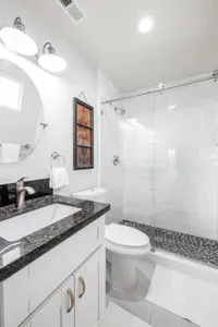 A sparkling clean full bathroom with a modern walk-in shower and stylish finishes—everything you need for a comfortable stay.