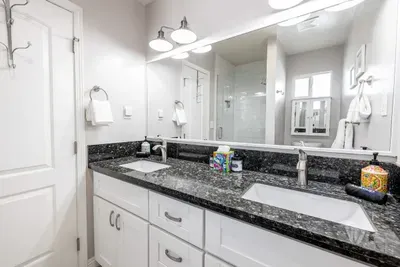 A sparkling clean full bathroom with a double vanity, tub/shower combo, and all the space you need to relax and refresh.