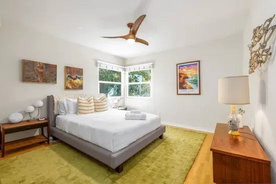 Adorned with a vibrant Sunset Cliffs art piece that captures the local California spirit and adds a pop of warm color to the room.