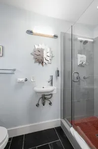 Includes a space-saving wall-mounted basin with a contemporary high-arc faucet and an iconic industrial tube light for perfect task lighting.
