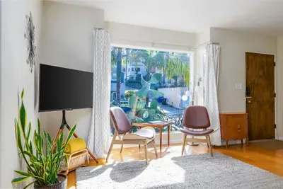 Lush Indoor-Outdoor Feel: Large windows and a thriving Snake Plant bring the vibrant California greenery right into your living space.