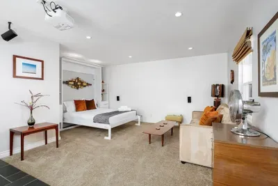 Includes a sleek, low-profile sectional sofa with velvet accent pillows, perfect for relaxing after a day of exploring
