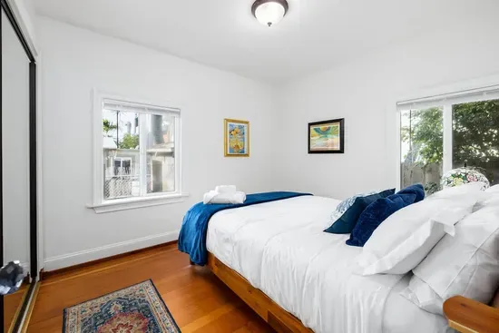 Our inviting bedroom offers a quiet escape. Sleep soundly in a plush bed, surrounded by natural light and minimal, calming decor.