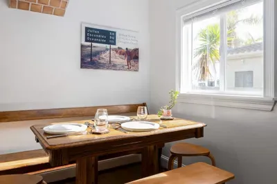 This inviting dining space combines rustic charm with natural light, making it the perfect spot for breakfast or a quiet dinner.