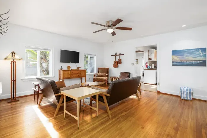 Step inside this picturesque and cozy craftsman home, featuring a bright, airy atmosphere and vintage charm. Enjoy the beautifully updated living space with classic wood flooring, comfortable seating, and a seamless flow into the open-concept kitchen