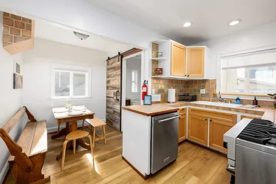 Enjoy the blend of rustic wood elements and modern appliances, perfect for a quiet morning coffee or a home-cooked meal.