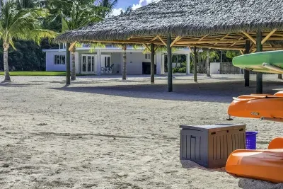 View from the beach of the tiki and kayaks