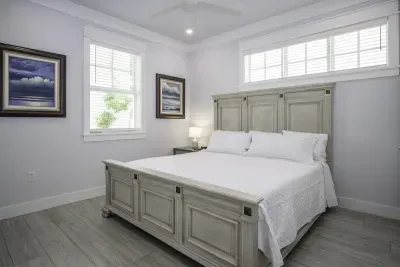 1st floor bedroom with fan and closets