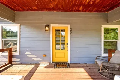 Covered porch behind the yellow door