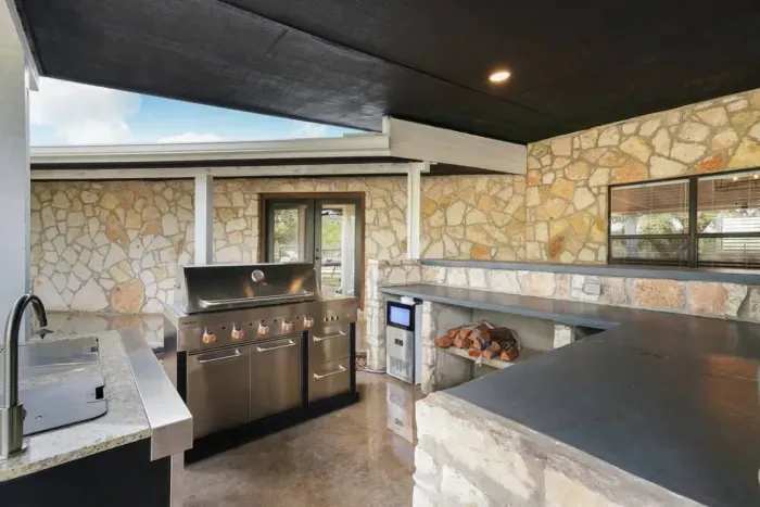 Entertain with ease and elevate your outdoor experience with our patio's top-of-the-line amenities, including a Char Broil grill for delicious BBQs, an ice maker to keep your drinks cool, and a convenient sink for effortless clean-up.