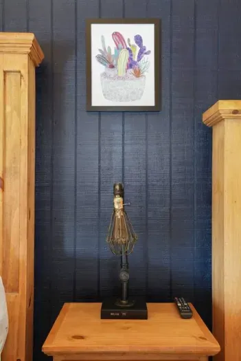 Immerse yourself in the rich and vibrant culture of the Southwest with our stunning decor, featuring intricate details like the lamp shade and frame on the wall.