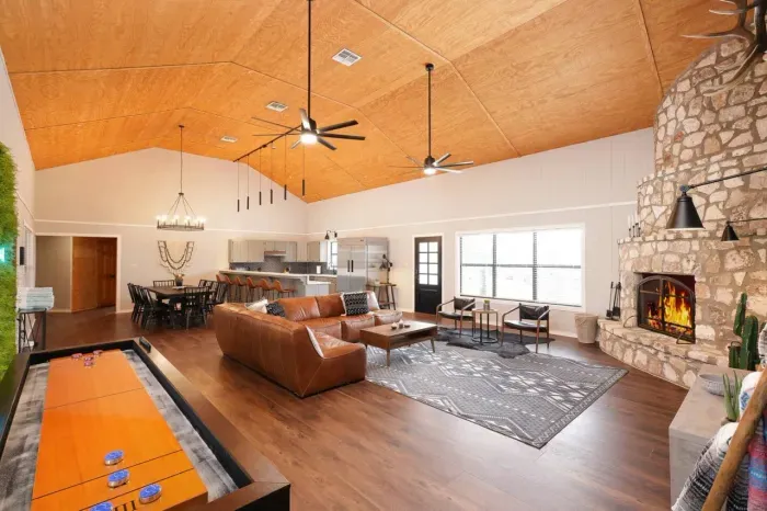 Experience the ultimate in comfort and entertainment in our spacious and open living area, complete with a charming fireplace, ample seating for relaxation, and a fun-filled shuffleboard for hours of friendly competition.